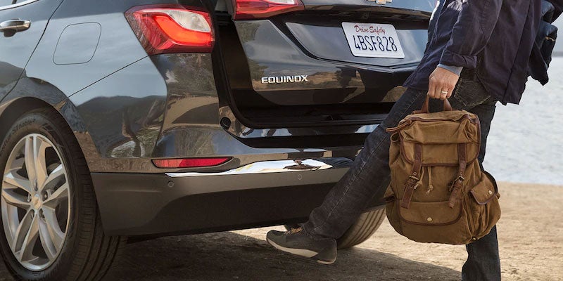 Person using the hands-free power liftgate of a 2021 Equinox.